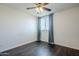 Bedroom offers hardwood floors, natural light, a ceiling fan, and neutral walls at 10925 E Toluca Ave, Mesa, AZ 85212