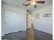 Bedroom features hardwood floors, white trim, double closets, and a ceiling fan at 10925 E Toluca Ave, Mesa, AZ 85212