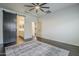 Bedroom with wood-look accents, modern ceiling fan, and ensuite bathroom at 10925 E Toluca Ave, Mesa, AZ 85212