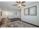 Bonus room with hardwood floors, a ceiling fan, light-colored walls, and natural light at 10925 E Toluca Ave, Mesa, AZ 85212