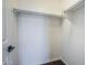 A walk-in closet with built-in shelving and laminate wood flooring at 10925 E Toluca Ave, Mesa, AZ 85212