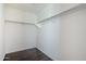 A walk-in closet with built-in shelving and laminate wood flooring at 10925 E Toluca Ave, Mesa, AZ 85212