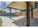 Expansive covered patio with stone accents offers a versatile space for outdoor living, overlooking the pool area at 10925 E Toluca Ave, Mesa, AZ 85212