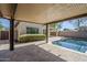 Relaxing covered patio provides shade and comfort with a view of the pool and backyard oasis at 10925 E Toluca Ave, Mesa, AZ 85212