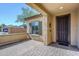 Covered porch with brick flooring, a secure front door, and clear views, provides shade and style to the home at 10925 E Toluca Ave, Mesa, AZ 85212