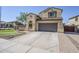 Inviting two-story home featuring a two-car garage, tile roof, and low-maintenance landscaping for enhanced curb appeal at 10925 E Toluca Ave, Mesa, AZ 85212