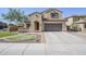 Inviting two-story home featuring a two-car garage, tile roof, and low-maintenance landscaping for enhanced curb appeal at 10925 E Toluca Ave, Mesa, AZ 85212
