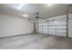 A spacious garage with an automatic door, concrete flooring, and ample room for parking at 10925 E Toluca Ave, Mesa, AZ 85212