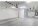 A spacious garage with an automatic door, concrete flooring, and ample room for parking at 10925 E Toluca Ave, Mesa, AZ 85212
