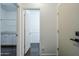 Hallway view showcasing access to a bathroom and secondary area with custom cabinetry at 10925 E Toluca Ave, Mesa, AZ 85212