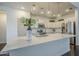 A closer view of the kitchen island with white countertops and stainless steel appliances and tiled backsplash at 10925 E Toluca Ave, Mesa, AZ 85212