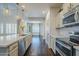 Modern kitchen featuring stainless steel appliances, tiled backsplash, and white countertops at 10925 E Toluca Ave, Mesa, AZ 85212