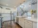 Bright kitchen with stainless steel appliances, white cabinets, and an island with a sink at 10925 E Toluca Ave, Mesa, AZ 85212