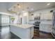 Open concept kitchen with stainless steel appliances and an island with countertop seating and pendant lights at 10925 E Toluca Ave, Mesa, AZ 85212