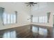 Bright and spacious living room featuring dark hardwood floors, high ceilings, and lots of windows for abundant natural light at 10925 E Toluca Ave, Mesa, AZ 85212