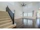 Open living room with high ceilings, large windows, dark wood floors, and a staircase provides lots of natural light at 10925 E Toluca Ave, Mesa, AZ 85212