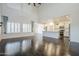 Spacious living room with dark wood floors, high ceilings, and abundant natural light flowing into the open-concept layout at 10925 E Toluca Ave, Mesa, AZ 85212