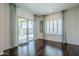 Bright living room featuring a sliding glass door and shuttered windows at 10925 E Toluca Ave, Mesa, AZ 85212