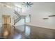 Bright, open living room featuring hardwood floors, a high ceiling, and a staircase leading to the second floor at 10925 E Toluca Ave, Mesa, AZ 85212