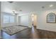 Spacious living room with a modern ceiling fan and hardwood floors with access to a hallway at 10925 E Toluca Ave, Mesa, AZ 85212