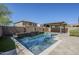 A private backyard pool with surrounding patio, a water feature, and a covered structure at 10925 E Toluca Ave, Mesa, AZ 85212