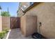 Functional side yard featuring paved surfaces and a private gate providing utility and convenience to the home at 10925 E Toluca Ave, Mesa, AZ 85212