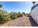 Gravel backyard with flowering oleander bush, AC unit, and shed at 11000 N 91St Ave # 20, Peoria, AZ 85345