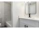 Bathroom featuring white vanity, sleek hardware, and a shower/tub combo in the background at 11000 N 91St Ave # 20, Peoria, AZ 85345