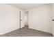 Bright bedroom featuring neutral walls, gray wood-look floors, and a closet at 11000 N 91St Ave # 20, Peoria, AZ 85345
