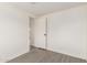 Bright bedroom featuring neutral walls, gray wood-look floors, and a closet at 11000 N 91St Ave # 20, Peoria, AZ 85345