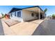 Wide shot of the home exterior showing a wide driveway, carport, and desert landscaping at 11000 N 91St Ave # 20, Peoria, AZ 85345