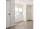 Hallway with luxury vinyl plank flooring, natural light, and two closet doors at 11000 N 91St Ave # 20, Peoria, AZ 85345