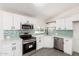 Bright kitchen features white cabinetry, stainless steel appliances, and a stylish subway tile backsplash at 11000 N 91St Ave # 20, Peoria, AZ 85345