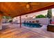 Lovely backyard with a pool, hot tub, covered patio, and desert landscaping against a block wall at 11085 E Mary Katherine Dr, Scottsdale, AZ 85259