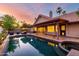Backyard featuring a sparkling pool, hot tub, and an outdoor seating area under the covered patio at 11085 E Mary Katherine Dr, Scottsdale, AZ 85259