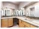 Bathroom featuring double sinks, tile countertops, and an abundance of mirror space at 11085 E Mary Katherine Dr, Scottsdale, AZ 85259