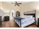 Relaxing bedroom with ample space, a ceiling fan, and a decorative fireplace at 11085 E Mary Katherine Dr, Scottsdale, AZ 85259