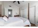 Bright bedroom with a vaulted ceiling, shuttered windows, and a sliding door closet at 11085 E Mary Katherine Dr, Scottsdale, AZ 85259