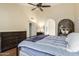 Stylish bedroom featuring a ceiling fan, modern furnishings, and plenty of natural light at 11085 E Mary Katherine Dr, Scottsdale, AZ 85259
