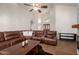 Spacious living room with high ceilings, a ceiling fan and a leather sectional sofa at 11085 E Mary Katherine Dr, Scottsdale, AZ 85259