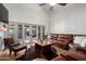 Spacious living room with french doors, a ceiling fan and a leather sectional sofa at 11085 E Mary Katherine Dr, Scottsdale, AZ 85259