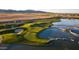Stunning aerial view of the golf course with water features, manicured greens, and nearby residential area at 11300 N Casa Dega Dr # 1005, Surprise, AZ 85388