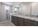 Modern bathroom with double vanity, granite countertop, and glass-enclosed shower at 11300 N Casa Dega Dr # 1005, Surprise, AZ 85388