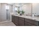 Contemporary bathroom with double sinks, sleek cabinetry, and glass shower at 11300 N Casa Dega Dr # 1005, Surprise, AZ 85388