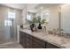 Modern bathroom featuring double sinks, granite countertops, and a walk-in shower at 11300 N Casa Dega Dr # 1005, Surprise, AZ 85388
