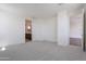 Spacious bedroom featuring neutral carpet and ensuite bathroom entrance at 11300 N Casa Dega Dr # 1005, Surprise, AZ 85388