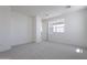 Bright bedroom featuring neutral carpet and ample natural light from large window at 11300 N Casa Dega Dr # 1005, Surprise, AZ 85388