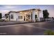 A well-lit entrance to the community building with a brick-paved driveway and manicured landscaping at 11300 N Casa Dega Dr # 1005, Surprise, AZ 85388