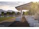 Exterior shot of a covered area showcasing lush landscaping, mountain views, and well-maintained lawn at 11300 N Casa Dega Dr # 1005, Surprise, AZ 85388