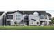 Modern townhome with a sleek gray facade, multiple windows, and a well-manicured lawn at 11300 N Casa Dega Dr # 1005, Surprise, AZ 85388